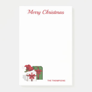 Weiße und grüne Geschenkboxen mit Weihnachtsmannmü Post-it Klebezettel
