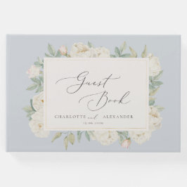 Weißfarbene Blume, hellblaues Gästebuch