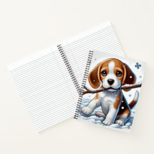 Welpe spielt im Schnee mit einem Stock im Winter Notizbuch