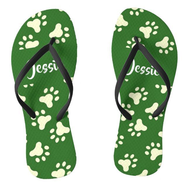 White dog paws on green flip flops (Fußbett)