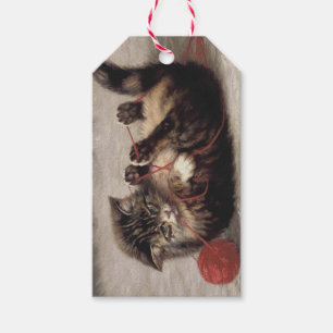 Wiegenlied der Katze, Eine Katze spielt mit einem Geschenkanhänger