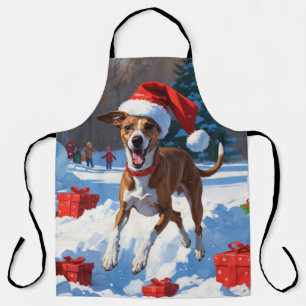 Windhund läuft im Schnee mit Weihnachtsmütze Schürze