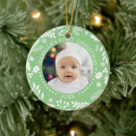 Winter Greenery Baby First Christmas Fotos Keramik Ornament<br><div class="desc">Ein perfektes Geschenk für Sie oder Eltern mit neuen Kindern. Dieses elegante Weihnachtsschmuck der Keramik besticht durch vorn und hinten durch Foto, die von einem Kranz der Wintergärten umgeben sind. "Baby's First Christmas" kurbelt über die Spitze jedes Fotos, mit dem Jahr darunter. Passen Sie dieses runde Ornament mit einem Kinderschmuck...</div>
