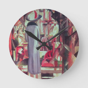 Woman in front of a large illuminated window runde wanduhr