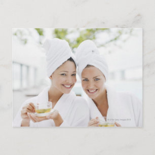 Women in bathrobes drinking tea at spa postkarte