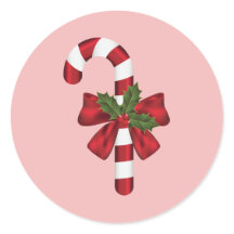 Zuckerstange mit Schleife und Weihnachtsholly auf