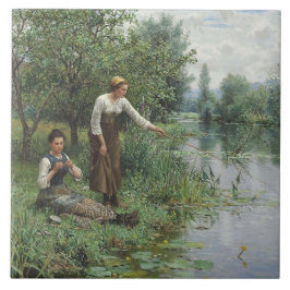 Zwei Frauen fischen auf dem Gras am Fluss Fliese