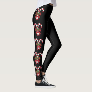 Zwei rote und weiße, festliche Kerzenleuchten auf Leggings