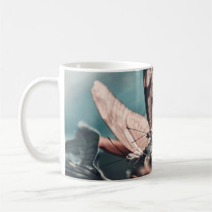 ZWEI SCHWARZSCHALTFLÄCHEN AUF DER SEITE VON BLUME KAFFEETASSE