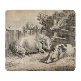 Zwei Schweine, die in Strohhalm in einem Außengebl Schneidebrett