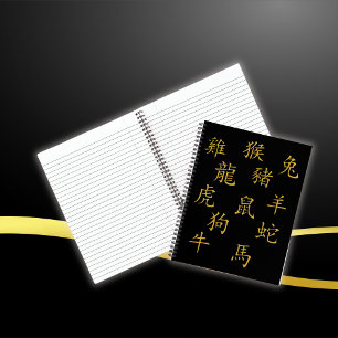 Zwölf chinesische Zodiakzeichen in Gold auf schwar Notizbuch